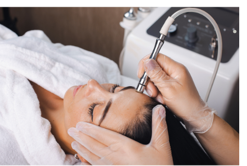 A skincare professional performing a microdermabrasion facial treatment, using a machine to exfoliate and remove dead skin cells, improving skin texture and promoting a smooth, youthful appearance.