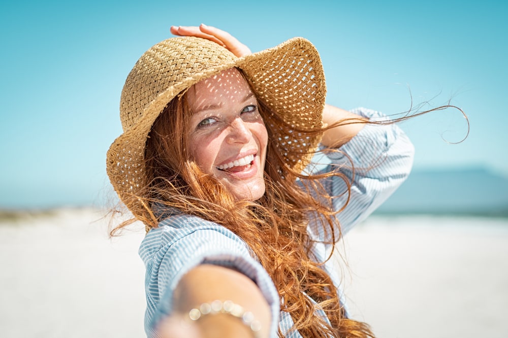 girl in a beach having a dewy & hydrated skin