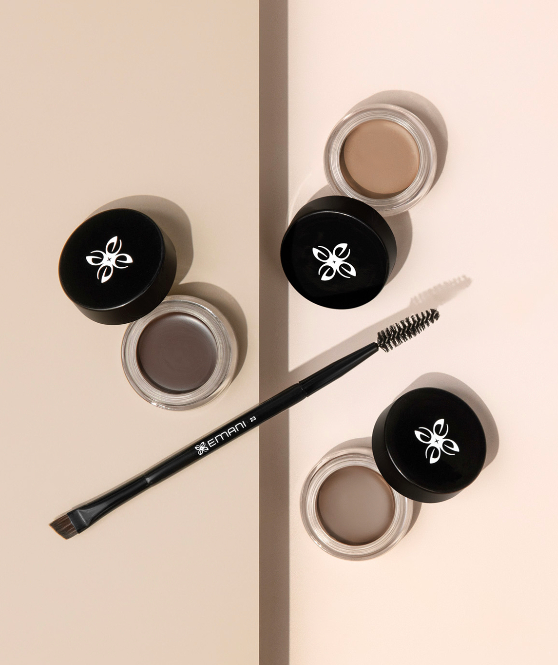 3 open jars of the Emani brow cream with brow brush