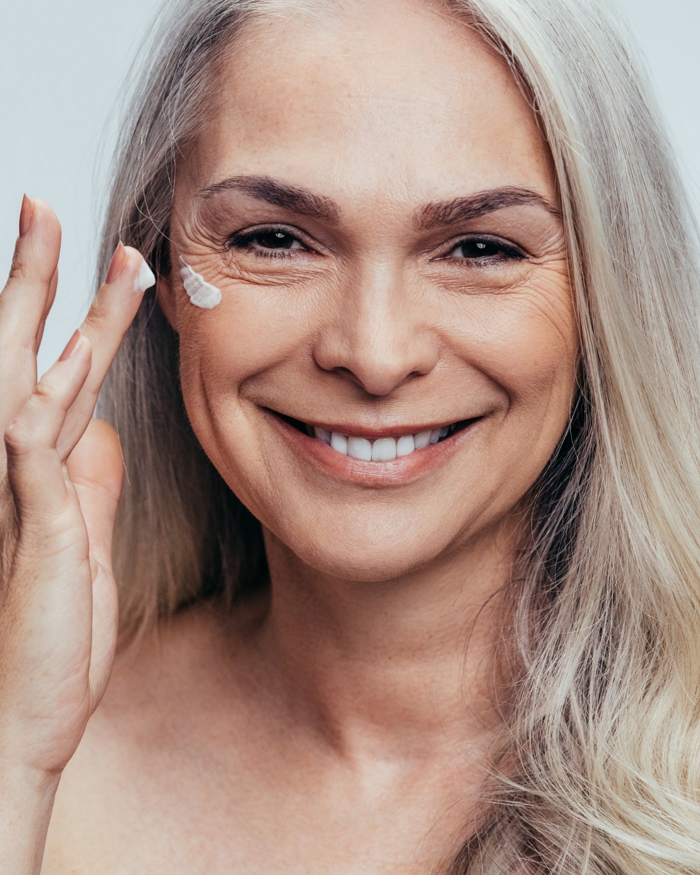 middle age women applying skin care