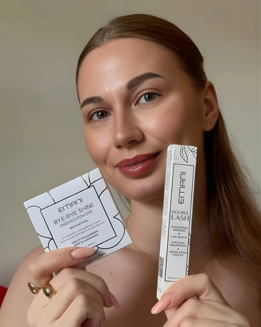 Woman holding Emani eyelash products against a neutral background | Alla Yakhnenko