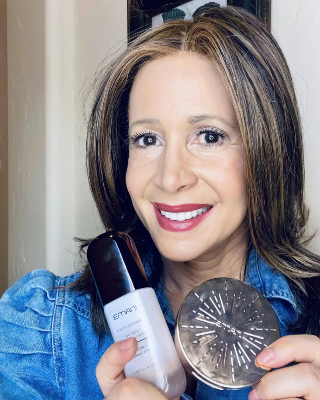 Woman holding Emani skincare products in front of a mirror | Beverly Garcia