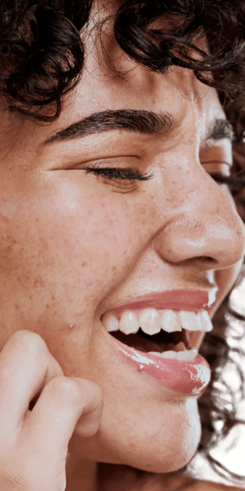 Close-up of a person's face with a focus on the eye and skin texture.